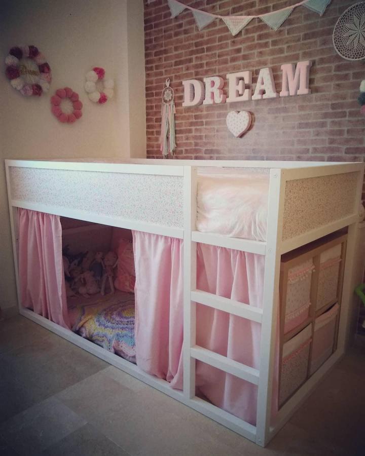 White and pink curtain-covered Ikea Kura bed with floral panels and side storage from @the_official_pompom_panda ikea kura bed ideas for small rooms cozy hideout.