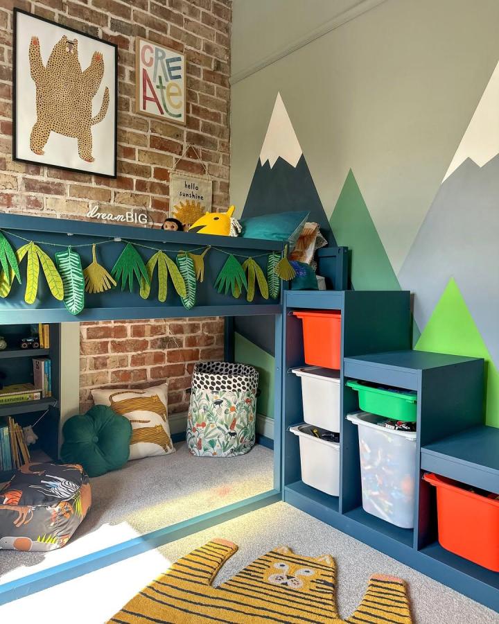 Deep blue painted Ikea Kura bed with built-in storage steps and leafy garland from @little_edwardian_semi ikea kura bed ideas for small rooms cozy play nook