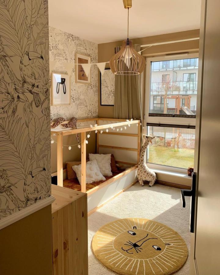 natural pine wood low Kura bed with canopy and string lights in bright small room from @dominika.byczek ikea kura bed ideas for small rooms