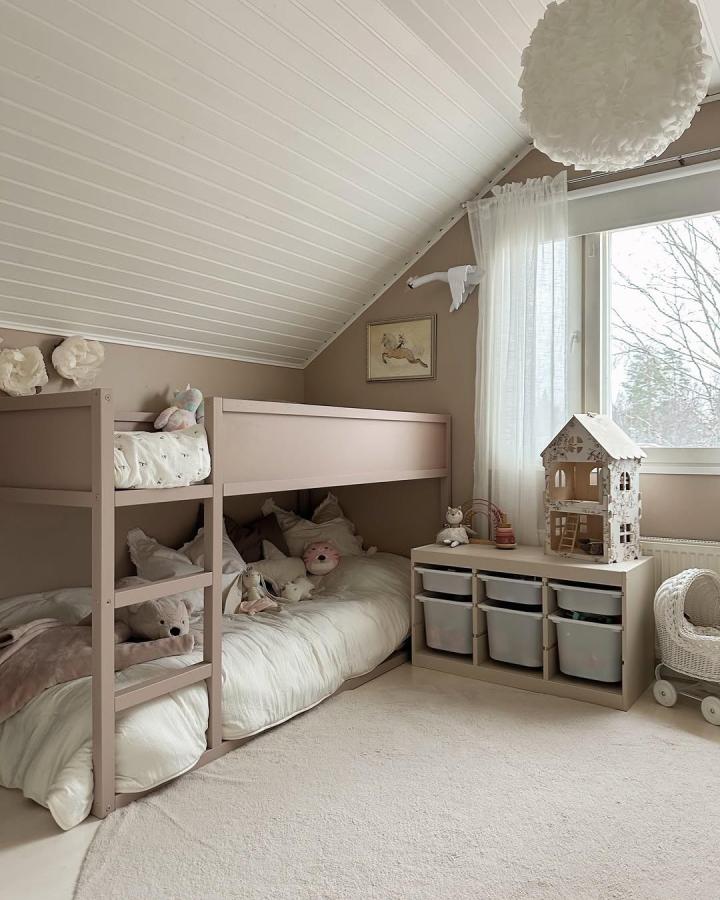 Soft beige painted Ikea Kura bed with cozy bedding and smart storage from @sallashouse in a small room.