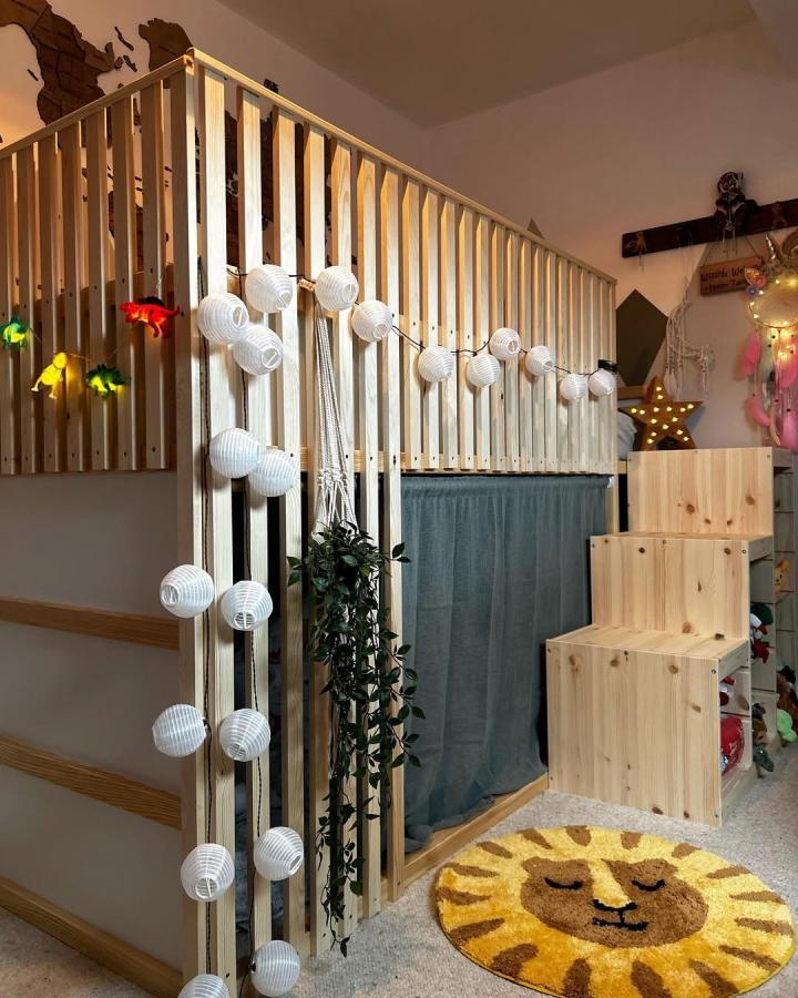 Natural pine wood ikea kura bed ideas for small rooms by @thebarnrenovation with added safety rail, curtain nook, and playful lights.