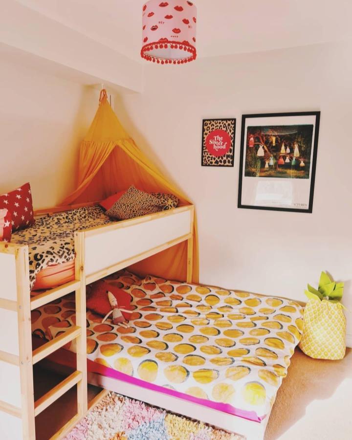 Yellow fabric canopy over Ikea Kura bed from @thelongmum brightens small room with playful, cozy design ikea kura bed ideas for small rooms