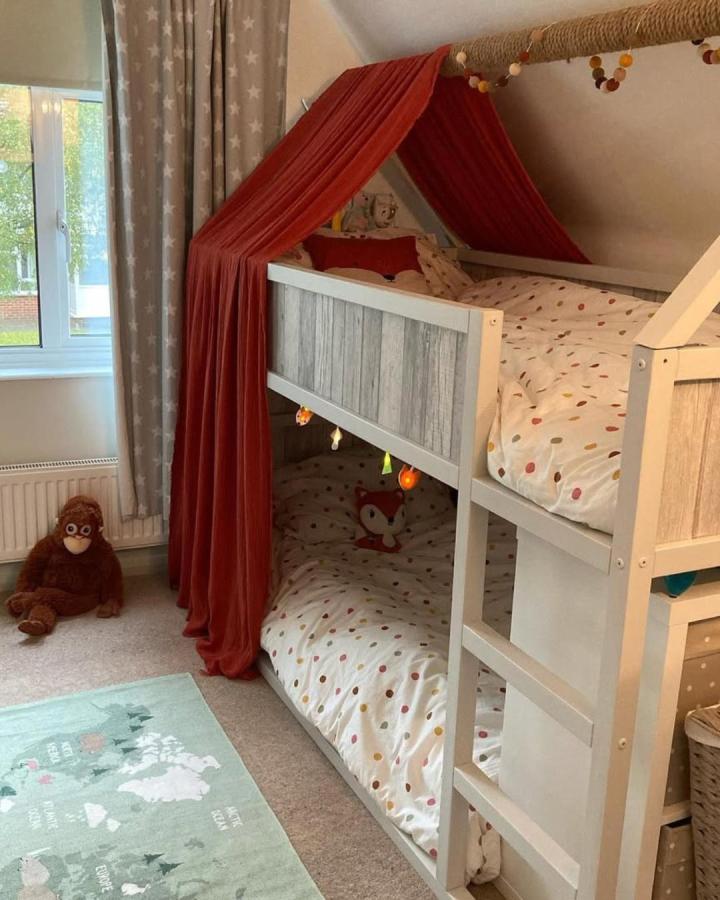rust colored fabric canopy on ikea kura bed from @home_with_helen_andco cozy and charming ikea kura bed ideas for small rooms