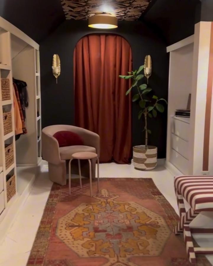 Black walls and rust curtain nook with PAX units in walk-in closet from @houseonasugarhill creating cozy stylish space.