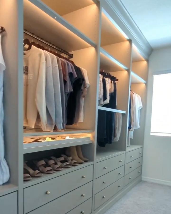 Soft gray Ikea Pax wardrobe system in a walk-in closet from @sheighvang with integrated lighting and organized storage shelves and drawers.