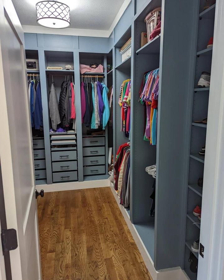 Light blue painted Ikea PAX walk-in closet with built-in drawers and hanging sections from @justageorgiaguy.