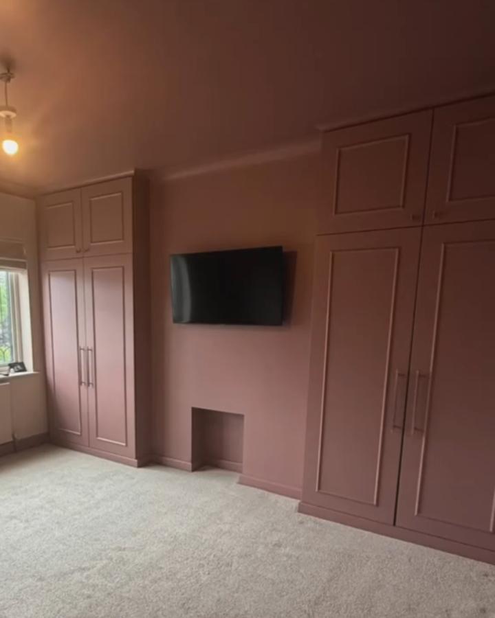 muted dusty rose built-in storage cabinets in bedroom from @the_coastal_corner_renovation clever ikea platsa hacks for awkward alcoves solution