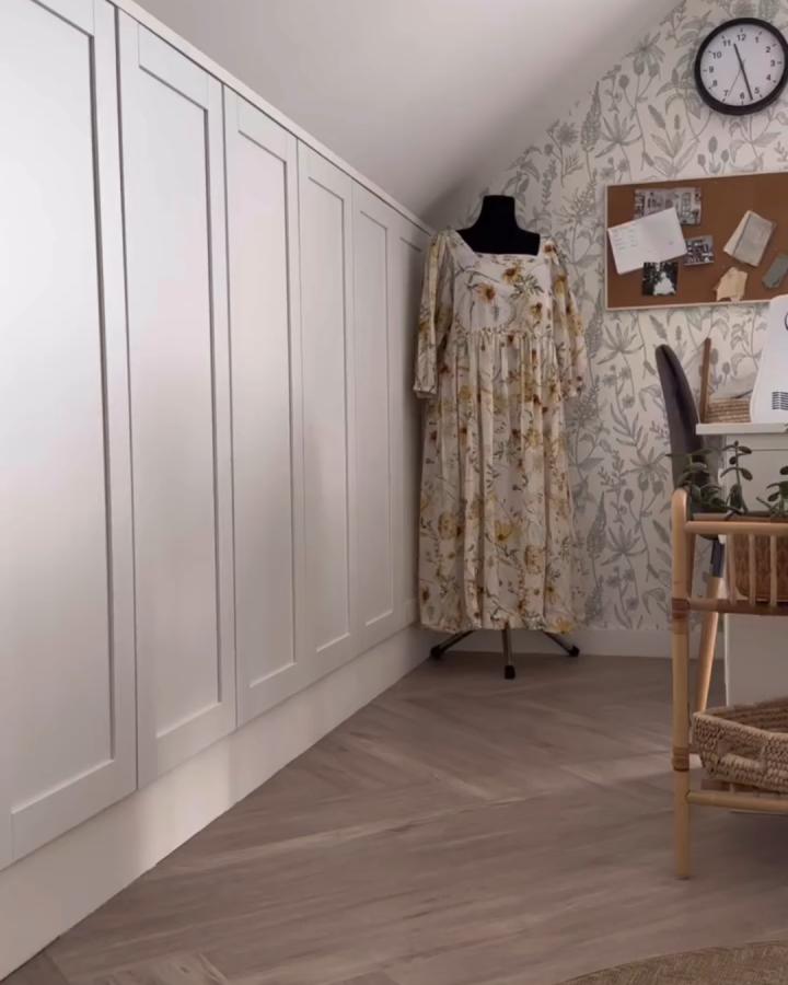 White paneled Ikea Platsa storage in a narrow alcove from @cihlovy.dum with floral wallpaper and light wood flooring.