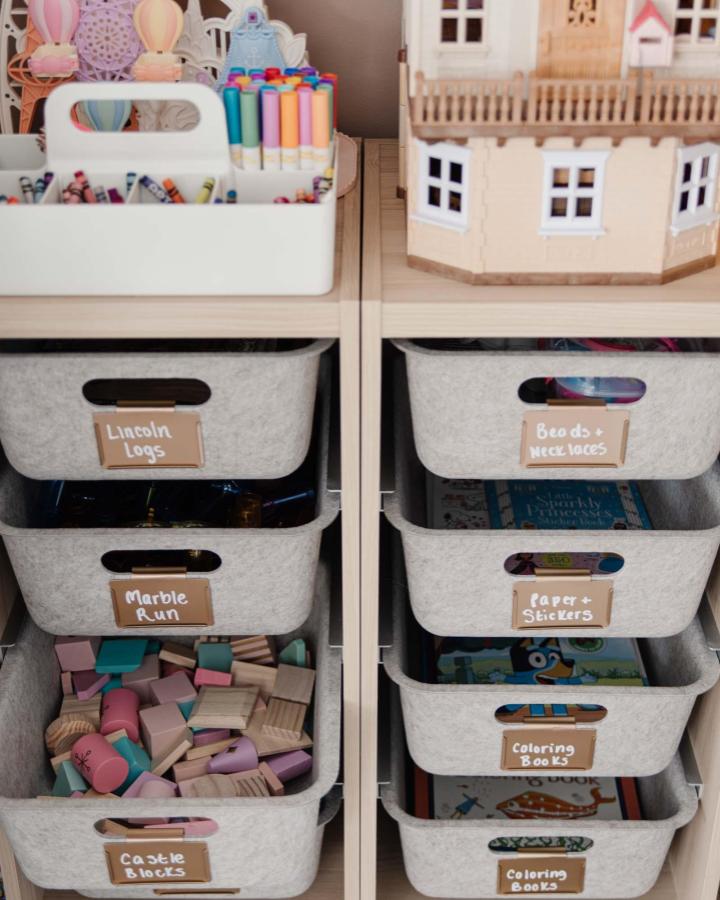 Soft gray felt baskets with leather labels for Ikea Trofast playroom ideas from caitlinmariedesign. Neatly organized craft and toy storage.