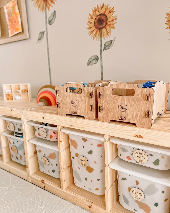 Natural wood Trofast storage with terrazzo bins and wooden labels from @hendrix.mahloh.winsley for ikea trofast playroom ideas.