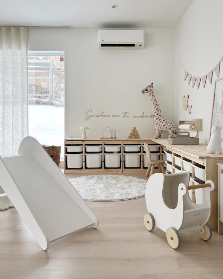 white and wood Ikea Trofast playroom ideas storage units from @fregnate with bins slide and child’s wooden cart