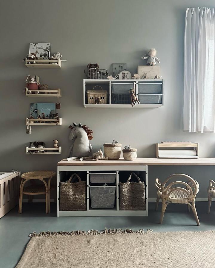 Natural woven baskets and gray bins Ikea Trofast playroom ideas by @enna.liebt featuring light wood shelves and wicker accents in a calm play space.