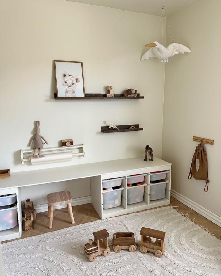 White Trofast storage bench and shelves from @nadjadoenvig in a minimalist playroom with wooden toys and neutral tones.