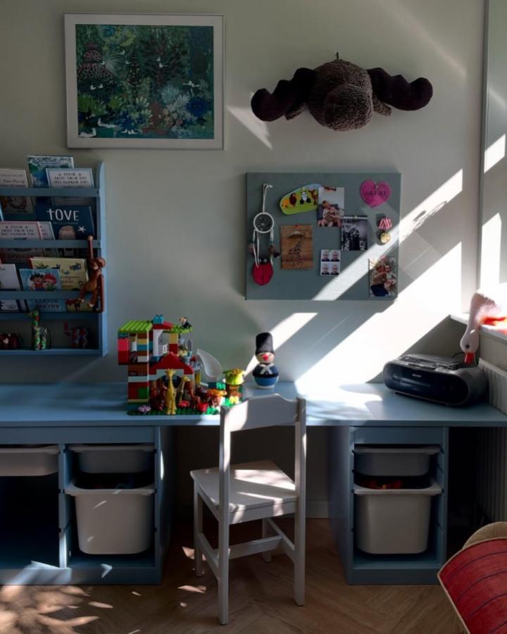 Soft blue painted Ikea Trofast playroom setup from @mariatylak featuring magnetic board and tidy toy storage.