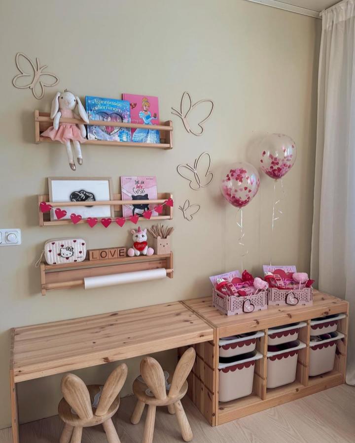 Natural wood Trofast storage and table setup from @emilialarss0n with butterfly wall art and kid-friendly playroom design.