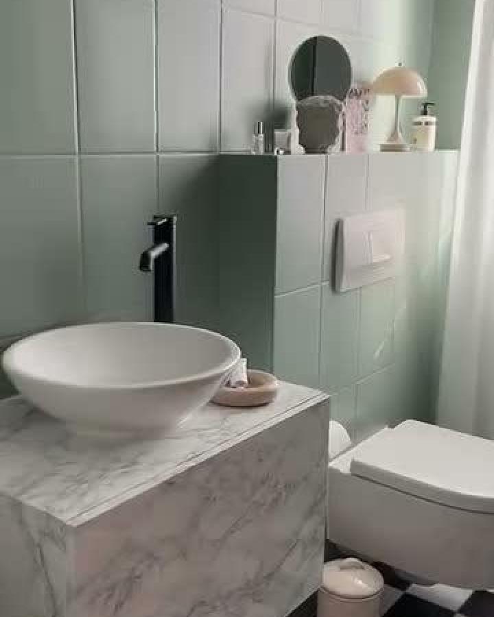 Marble-effect Besta cabinet with mint green tiles and white basin in bathroom by @sue.and.stu ikea besta bathroom vanity ideas sleek style modern contrast