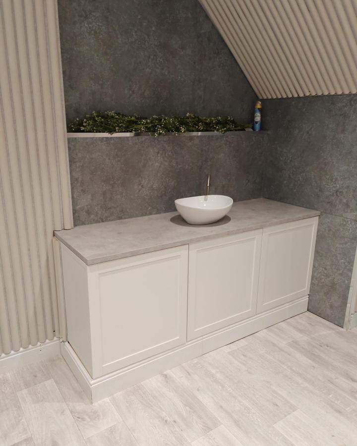 white shaker-style ikea besta bathroom vanity ideas with concrete countertop and vessel sink by Matt Dabrowski in modern bathroom setting