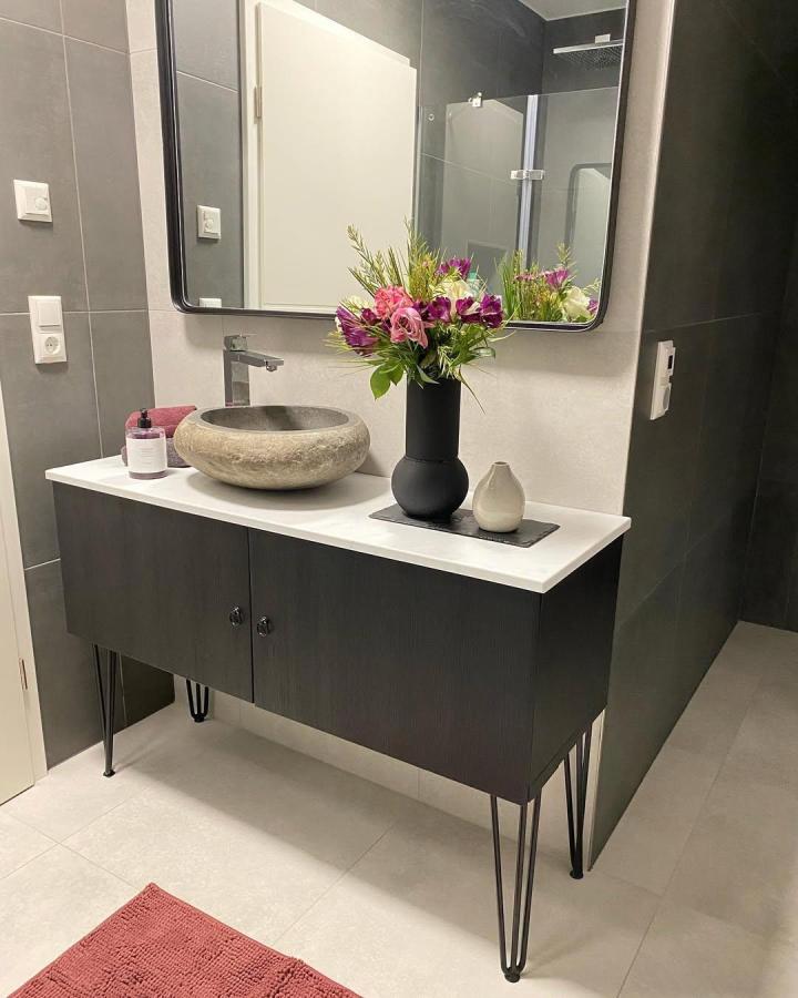floating black textured ikea besta bathroom vanity ideas with stone vessel sink and hairpin legs in modern bathroom by @9burcu0 bright white countertop and fresh flowers