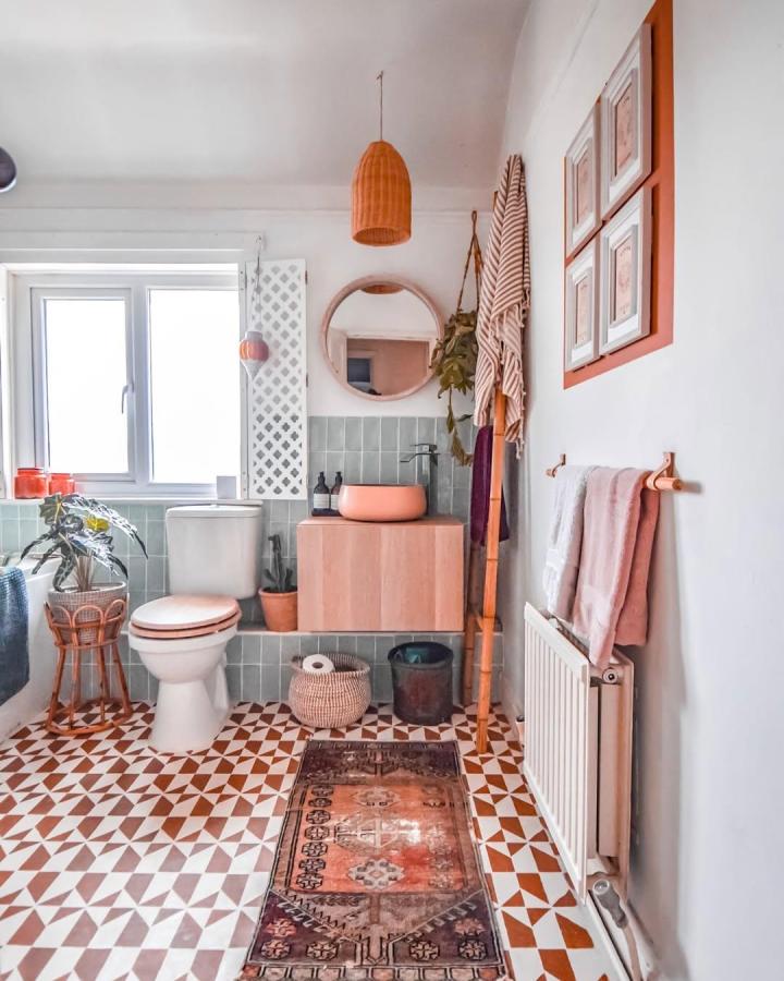 Pale wood floating vanity with concrete planter sink in cozy bathroom by @iamhayleystuart. Stylish ikea besta bathroom vanity ideas with green tile and terracotta tones.