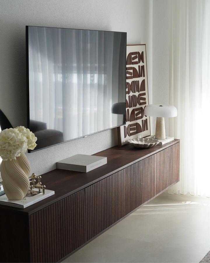 dark walnut wood slat front ikea besta bench hack floating media console with decor from @studiofedde in bright living room sunlight