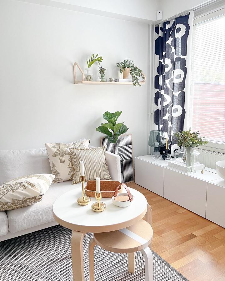 white minimalist ikea besta bench hack in living room from @stweck with bold patterned curtains and simple decor