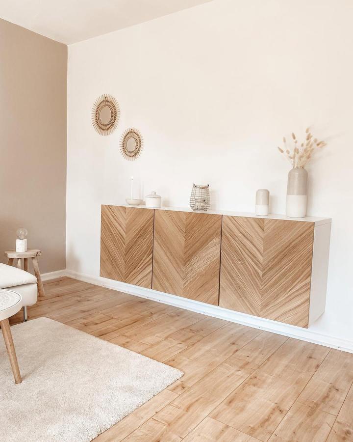Warm chevron wood front ikea besta sideboard hacks floating in minimal living room from @sophiesliving. Natural wood grain design with white base.