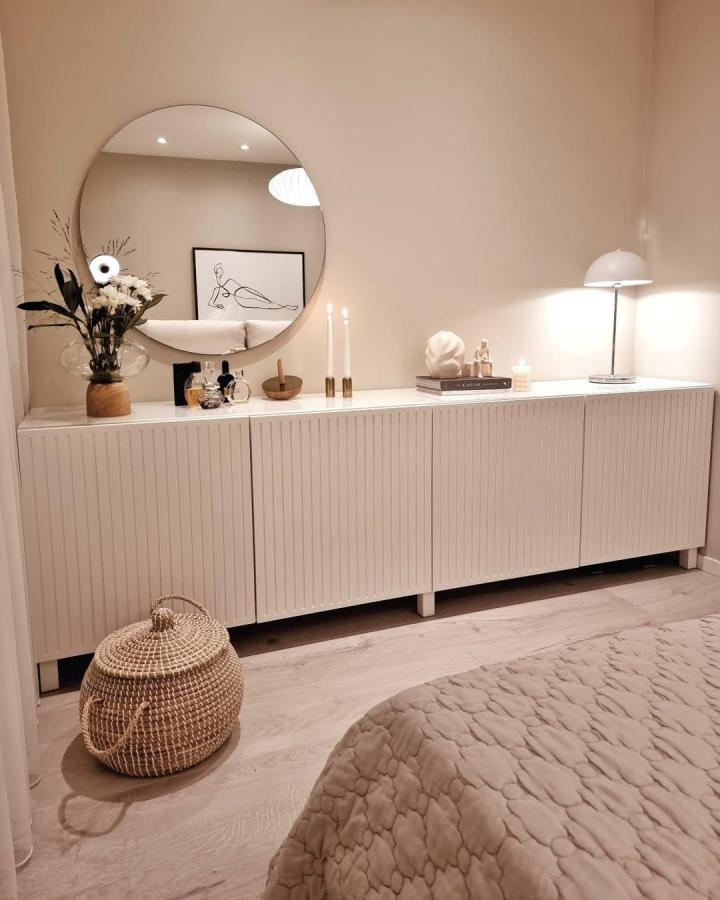 White vertical slat textured ikea besta sideboard hack with cozy room decor from @merals_home.