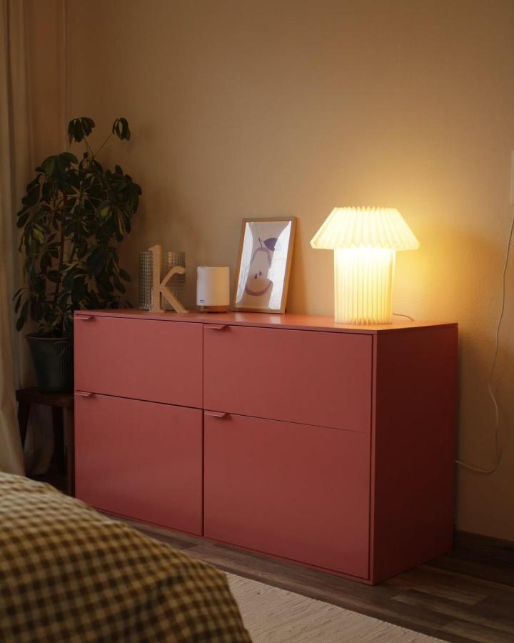 Terracotta matte finish Ikea Besta sideboard hack in cozy room by @rosarotes.zuhause soft lighting and minimalist decor