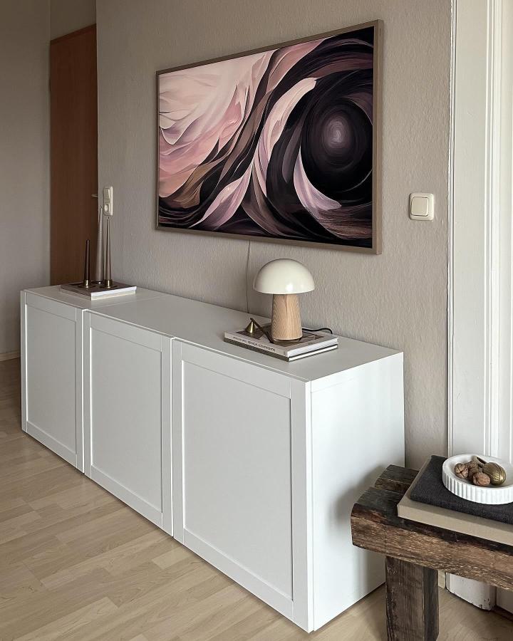 White minimalist Ikea Besta sideboard with mushroom lamp and abstract wall art from @scandi_interior_lover in modern home setting.