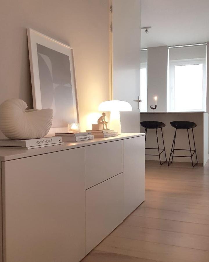 white minimalist ikea besta sideboard hacks in cozy modern interior with soft lighting and art from @savitahartsteen
