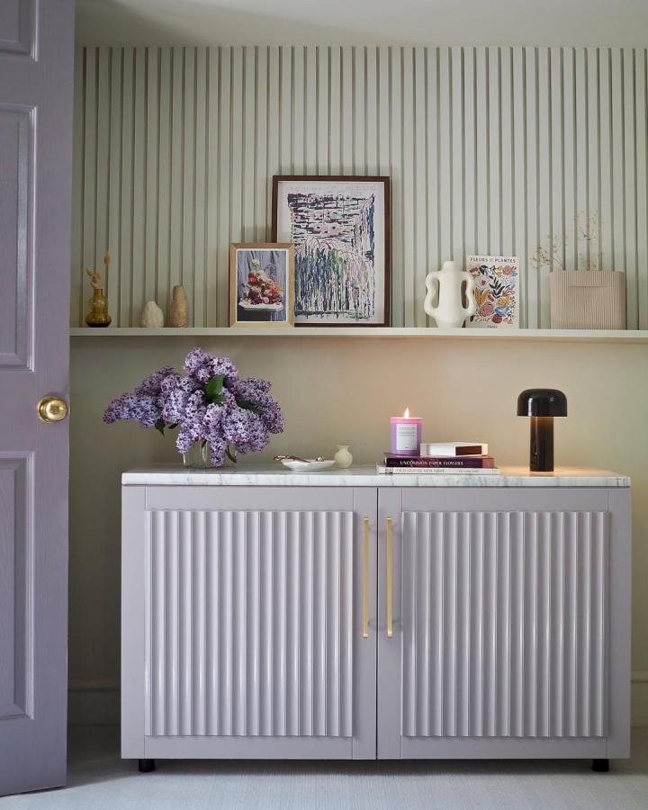 Soft lavender fluted front ikea besta sideboard hacks with gold handles and marble top styled with lilacs and art from melanielissackinteriors.
