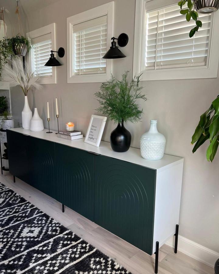 Deep green sculpted door Ikea Besta sideboard with black legs and white top by @norseinteriors in modern living room setting.