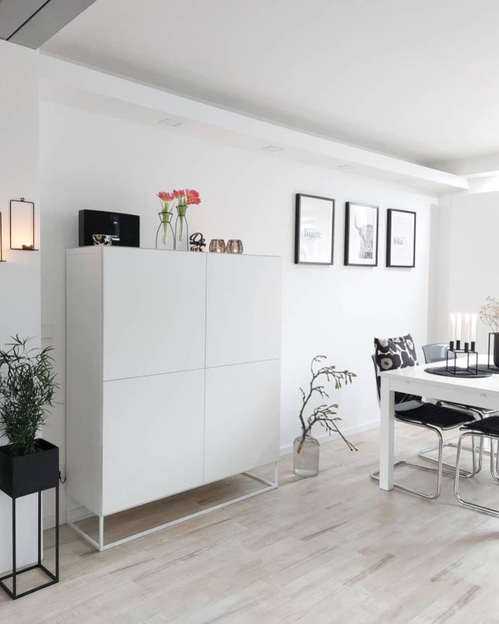 White minimalist ikea besta sideboard hacks in modern dining room by @interiorbyela_ with metal base uplift and sleek decor.