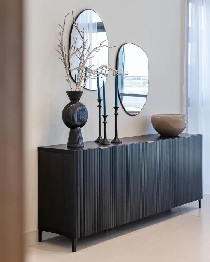 Black ribbed front ikea besta sideboard hacks in modern living room with artistic decor from @fronteriors showing sleek styling and minimal design.