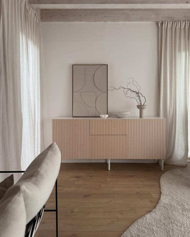 Blush slatted front ikea besta sideboard hacks in airy room with natural wood floor and linen curtains by @interior.with.sabi. Minimalist and textured design.