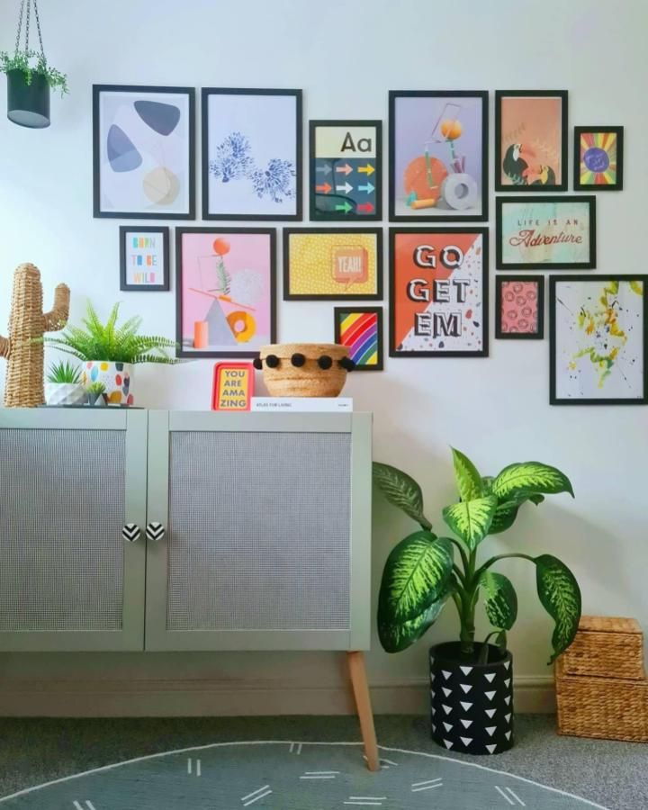 Soft sage green Ikea besta sideboard hacks with mesh doors and wooden legs in a cozy living space by @all_things_interior_. Stylish and practical storage solution.