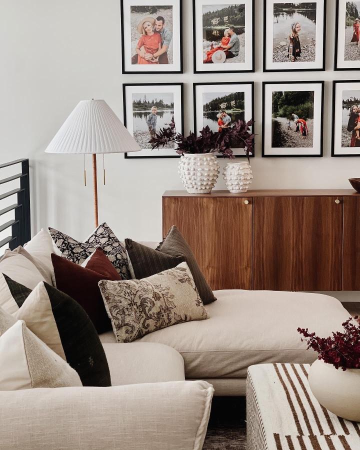 Warm walnut wood ikea besta sideboard hacks styled with modern brass knobs in a cozy living room by @theryanhaus_.