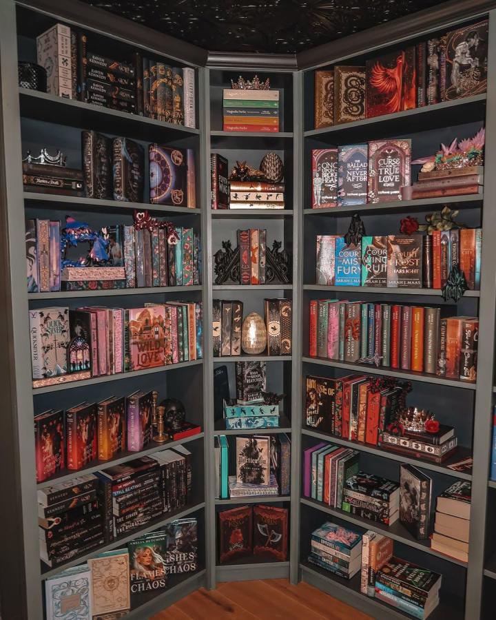 Dark gray painted corner ikea billy library wall hacks with decorative black bookends and fantasy book collection from @bellasdragonden. Cozy dramatic storage unit.