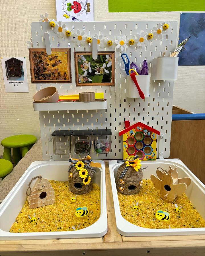 yellow and natural wood bee-themed sensory table from @jufxkyana with decorated beehives and craft tools for ikea flisat sensory table ideas