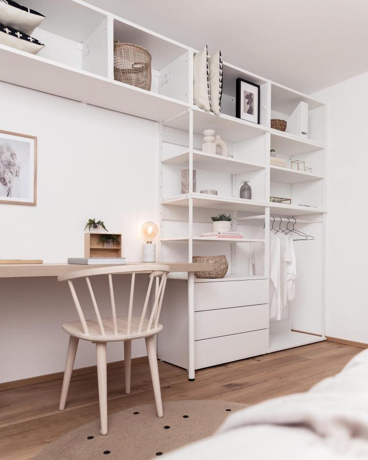 White open-frame Ikea Platsa wardrobe hacks with drawers and hanging space in minimalist bedroom from @jennyhaimerl_com. Shelving and storage combo with natural accents.