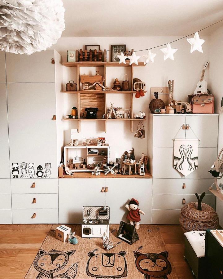 Neutral cream ikea platsa wardrobe hacks with natural wood shelves and playful kids room decor from @minchelino showing toy storage and cozy details