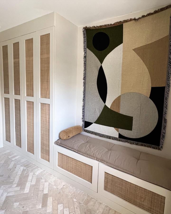 Natural rattan and beige cushioned ikea platsa wardrobe hacks with built-in seating and wall art from @valerie.philomena. Cozy and stylish storage solution.