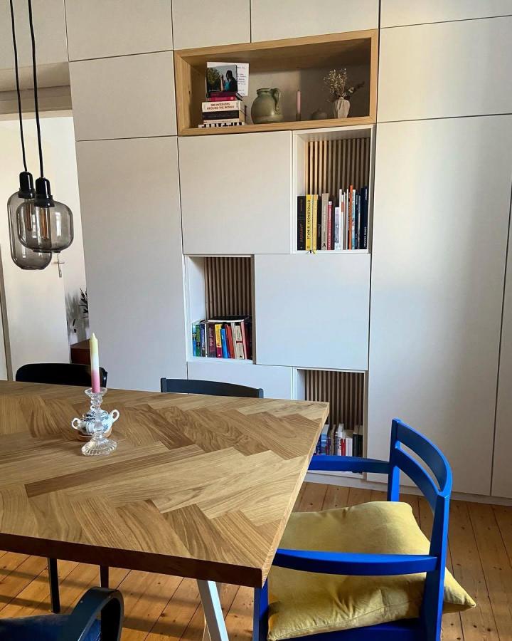 White and natural wood mix ikea platsa wardrobe hacks with open shelves and slatted wood back panels by @weisskoenigsblau in a modern living space.