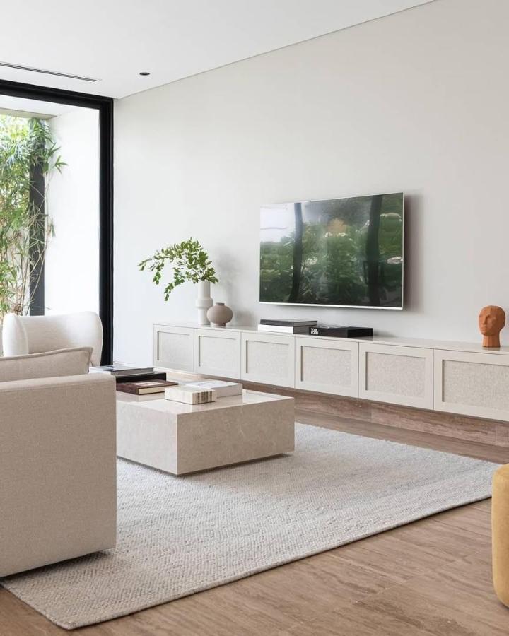 Light beige textured panel ikea besta floating tv unit ideas in bright minimalist living room by @fronteriors with natural wood floor and simple decor.