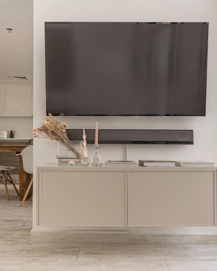 Cream toned floating Ikea Besta TV unit ideas from @fronteriors with simple decor and clean lines.