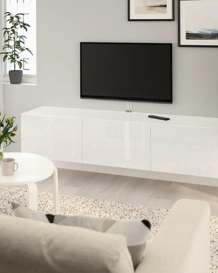 Glossy white ikea besta floating tv unit ideas from @ourcavan_home with clean modern design and wall-mounted style in a bright living room.