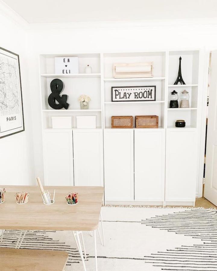 White Ikea Billy Oxberg bookcase ideas with clean design, open shelves, closed doors, and natural accents by @em.and.eli.co in a playroom setup