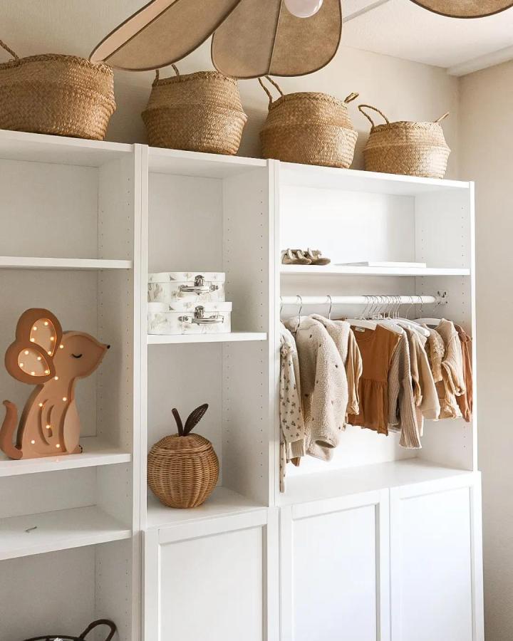 White Billy Oxberg bookcase with woven baskets and hanging rod by @juudithhome showcasing ikea billy oxberg bookcase ideas with natural textures and storage options