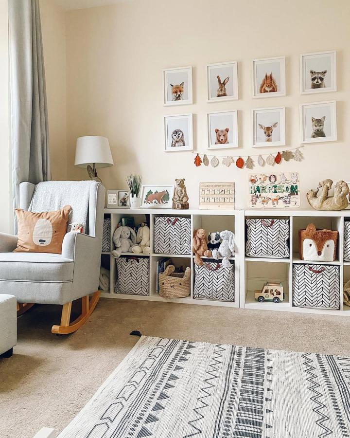 Neutral patterned storage bins in a cozy playroom setting from @lifeatolddenehouse feature ikea kallax toy storage ideas with plush toys and wooden accents.
