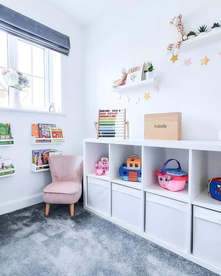 White Kallax toy storage with soft bins in a bright child’s room by @athomewithchelle, neat and organized play space.